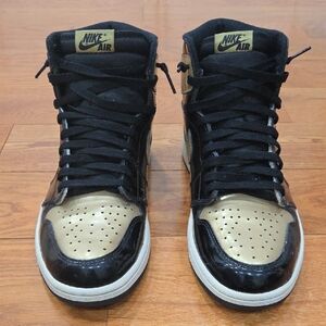 Nike Air Jordan Retro 1 High-Top Patent Sneakers in Black and Gold